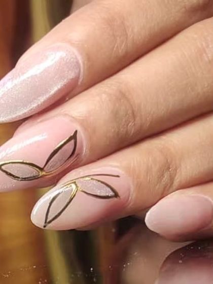 A minimalist and elegant design with a delicate gold leaf outline on a soft pink base.