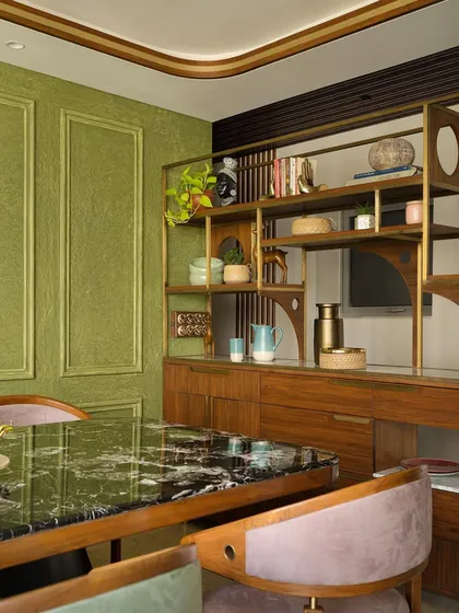 The dining area console, which showcases unique souvenirs and collectibles within a beautifully crafted wooden and brass shelving unit.
