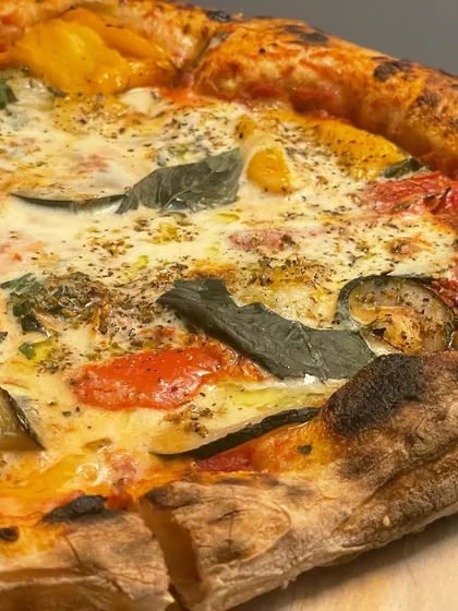 An experimental pizza featuring creamy burrata and roasted vegetables. I love playing with different combinations to create new and exciting flavors for my guests.