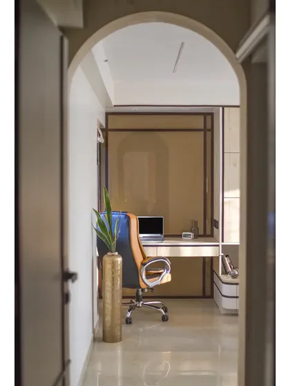 A view through an arched doorway into the home office. The use of arches creates a sense of flow and visual continuity throughout the home.