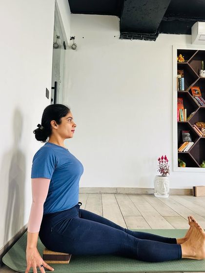 When using harder props like blocks for support in Dandasana, the sit bones do not sink. This makes it easier to extend the spine vertically, which is key for learning proper posture and spinal alignment.