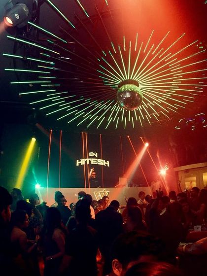 A wide shot of the party at Wafira, Kolkata. The disco ball, the lights, and a dance floor full of people create a visual spectacle that matches the audio experience.