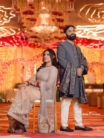 A stylish, posed portrait of the couple at their reception, exuding grace and elegance.