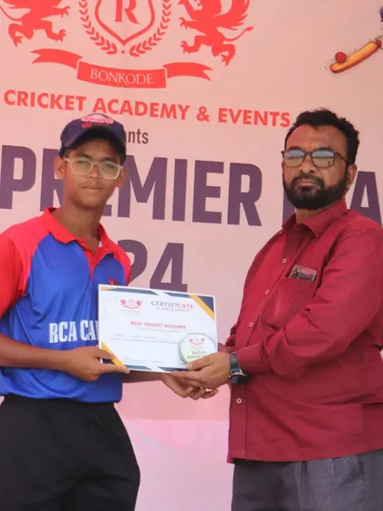 A player from the RCA Capitals receives his participation certificate. Every player who competes is a part of our journey.