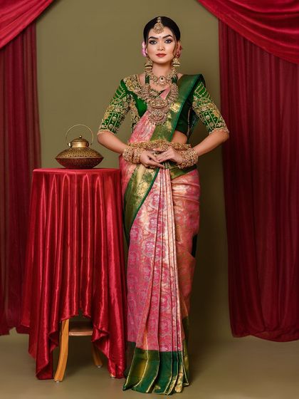 The full view of the bride standing, showcasing the beautiful saree drape and overall majestic look.