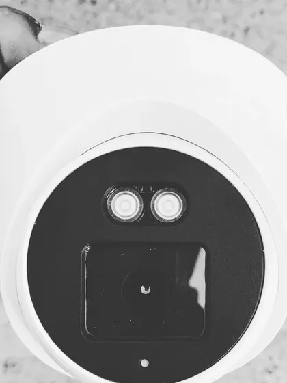 A black and white shot highlighting the design of a modern turret camera. We also offer repair and maintenance services.