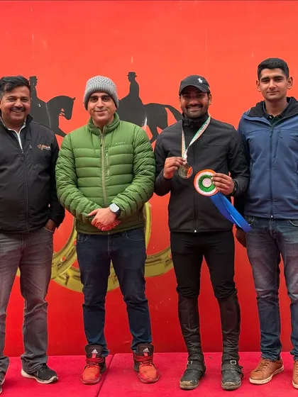 Our coach stands with a silver medalist from the CCN Introductory Eventing. Our experienced coaches are the cornerstone of our riders' success.