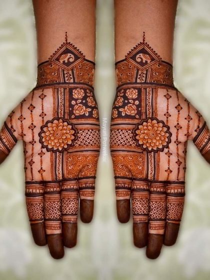 A symmetrical design with a central floral mandala on the palm, complemented by geometric patterns and elephant motifs on the wrist.