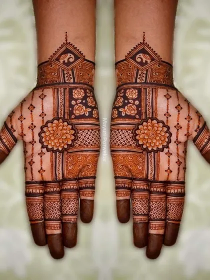 A symmetrical design with a central floral mandala on the palm, complemented by geometric patterns and elephant motifs on the wrist.