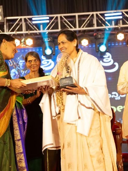 Presenting an award to a fellow artist at the Shivaratri Utsava. Celebrating the achievements of others is just as important as receiving honors oneself.
