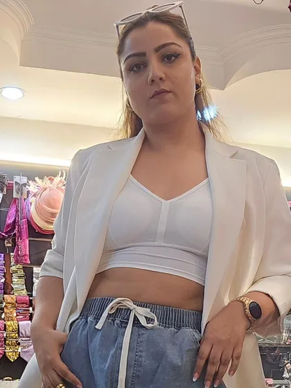 The full power look, pairing a white blazer and crop top with denim joggers. The gold watch and statement earrings from our collection tie it all together for that effortlessly cool vibe.