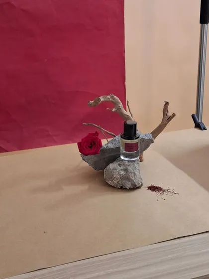 A raw, unedited look at our still life setup for a perfume, with natural stone and driftwood props.