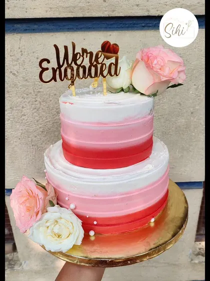 Lately, I've been on a kick of simple and floral designs. This two-tier engagement cake features a beautiful red and pink ombre effect, adorned with fresh roses for a classic, romantic look.