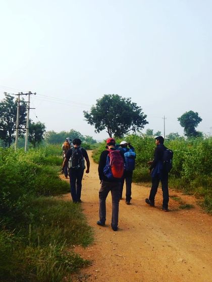 The team moving as a unit along a dirt track, the first step on a long journey into the wilderness.