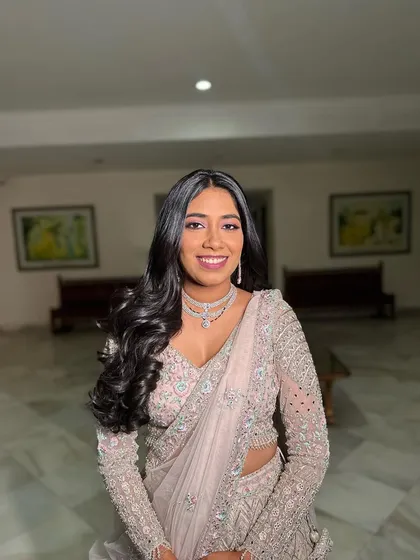 A beautiful smile from a happy bride. Her full glam waves perfectly complement her embellished gown for a show-stopping reception look.