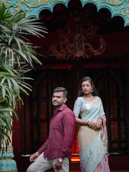 A stylish pose against a grand red and gold doorway, part of our royal-themed sets.