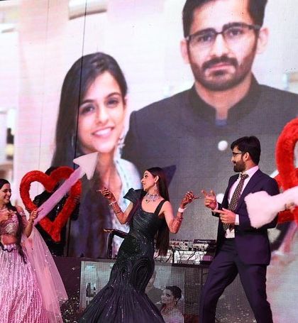 The bride's squad using fun props like hearts on a stick to add a playful touch to their performance.