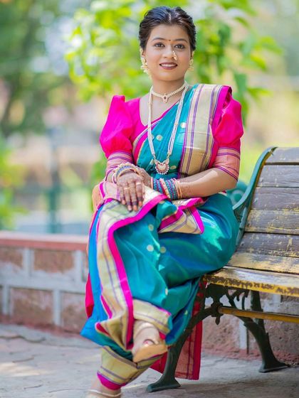 A full-length view of the soft textured hairstyle and Nauvari saree draping. The complete look is a perfect blend of traditional attire and modern, relaxed hairstyling.