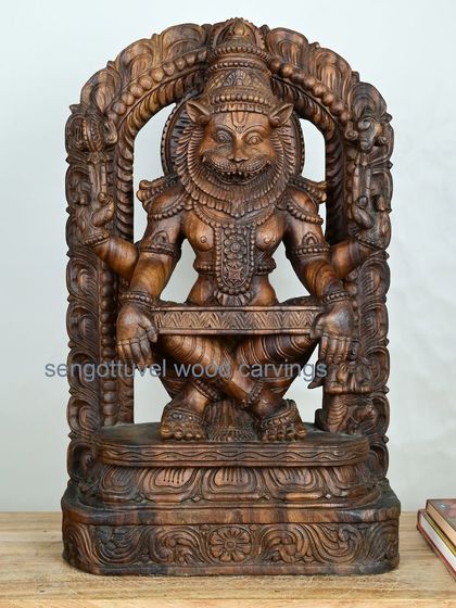 A powerful 26-inch sculpture of Lord Narasimha, the fierce lion avatar of Vishnu. This piece is carved from Vaagai wood and captures the intensity and divine strength of the deity.