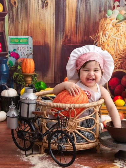 A happy little chef in her rustic kitchen. The abundance of colorful fruits and vegetables creates a vibrant and playful scene.