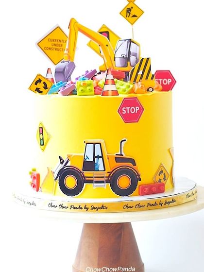 This construction theme cake was a special request, combining construction vehicles with colourful Lego blocks. It's a bright yellow vanilla cake, perfect for a child who loves to build.