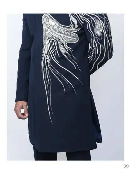 The back and side view of the navy bandhgala with phoenix embroidery. The design wraps around the sleeve, ensuring you make a statement from every angle.