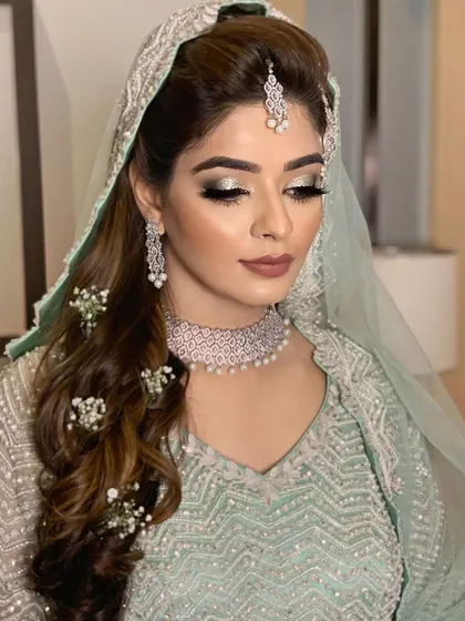 A close-up of Farheen's eye makeup, showcasing the beautiful blend of silver and grey tones for a soft yet glamorous look.