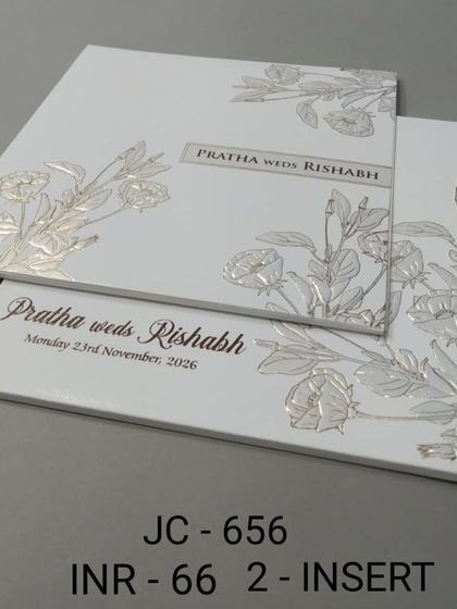 This minimalist white card features silver foil embossed flowers for a subtle, textured look. It's an affordable and stylish option for a modern wedding.