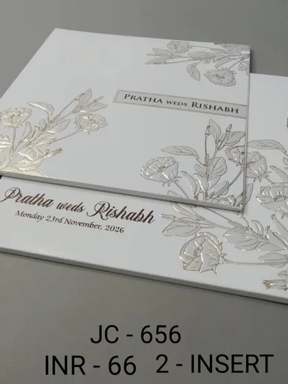 This minimalist white card features silver foil embossed flowers for a subtle, textured look. It's an affordable and stylish option for a modern wedding.