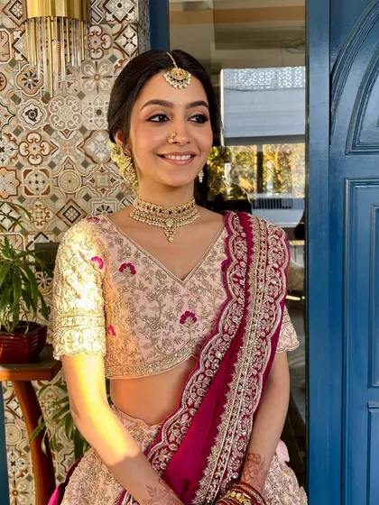 The perfect bridal portrait. The soft light highlights her radiant skin and the delicate embroidery of her pink lehenga.
