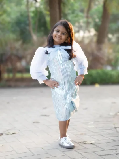 Posing with her hands on her hips, full of personality. I love it when kids show off their unique style and attitude during our sessions.
