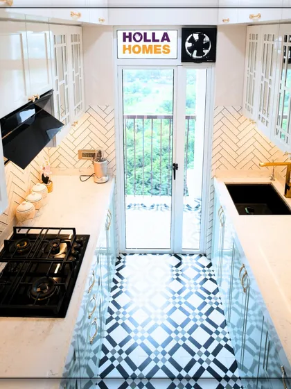 A kitchen can be both highly functional and a work of art. For this home, we designed a vintage-inspired modular kitchen with a beautiful PU finish, herringbone backsplash, and patterned flooring, proving that practical spaces can have immense character.