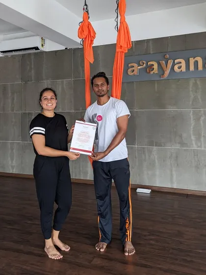 An instructor and student pose with the certificate, a symbol of a shared journey of learning and growth.