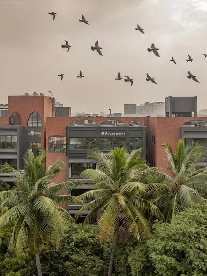 Our ARCUS residential project in Chennai is nestled within a dense urban neighborhood surrounded by trees. This image captures how the building coexists with its green surroundings, a result of our careful planning to preserve the existing foliage and integrate the structure with nature.