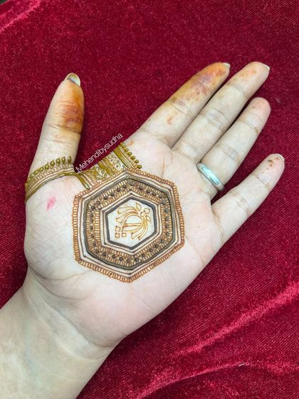 The start of a minimalist design, showing a hexagonal centerpiece with a symbol inside. This is perfect for someone who wants a very small and personal tattoo-like design.