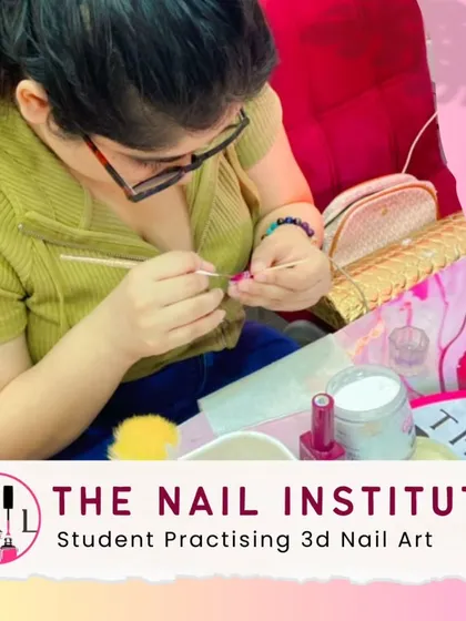 A student carefully sculpts a 3D element onto a practice nail, learning the delicate art of adding texture and dimension.