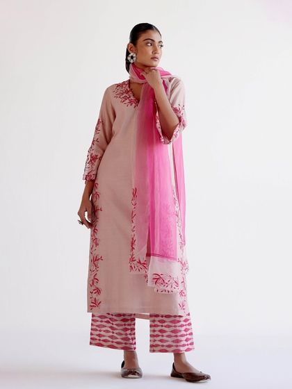 A full look of the pink embroidered kurta paired with tie-dye patterned trousers and a sheer dupatta, creating a breezy, chic ensemble.