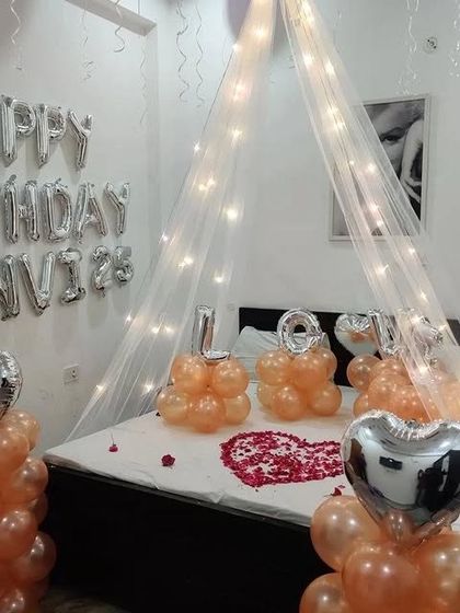 Another angle of the romantic room decor, showing the "Happy Birthday" foil balloons on the wall.