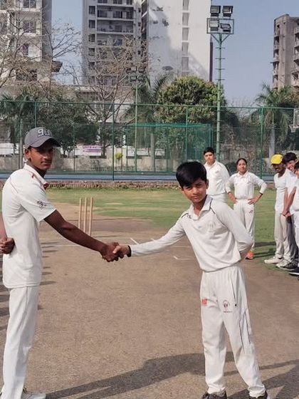 The captains of GNCC and SKCA Tigers shake hands before a practice match. This gesture embodies the spirit of sportsmanship we promote.