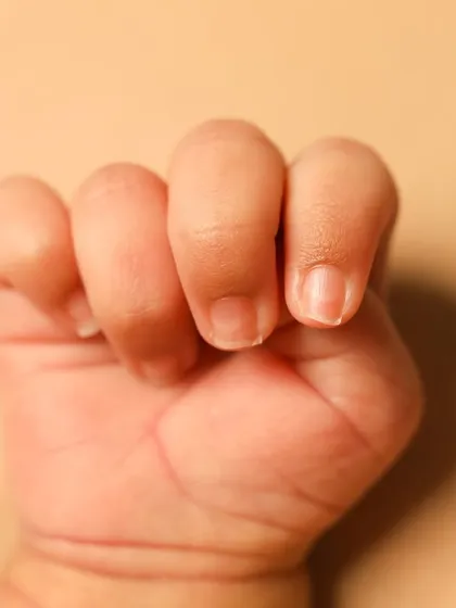 A close-up of a perfect little newborn hand. Every wrinkle and nail is a detail to be cherished forever. So tiny.
