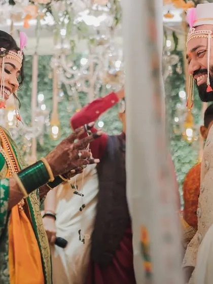 The smiles exchanged during traditional rituals are just priceless. Here's a beautiful moment from a Marathi wedding, capturing the playful connection between the bride and groom during the ceremony, a memory they will cherish forever.