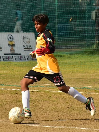 Our goalkeeper confidently advances with the ball, ready to start an attack from the back.