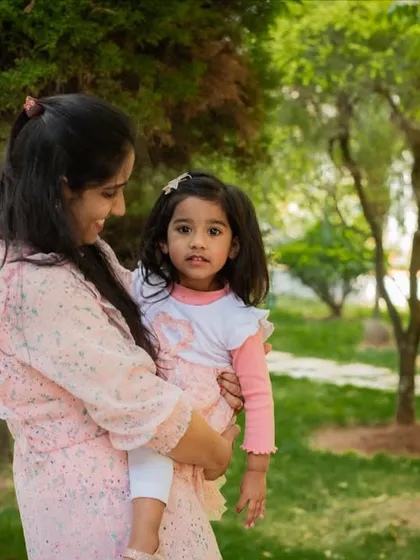 A mother holding her daughter in a beautiful park. My outdoor family sessions are relaxed, allowing for natural and loving portraits like this one.