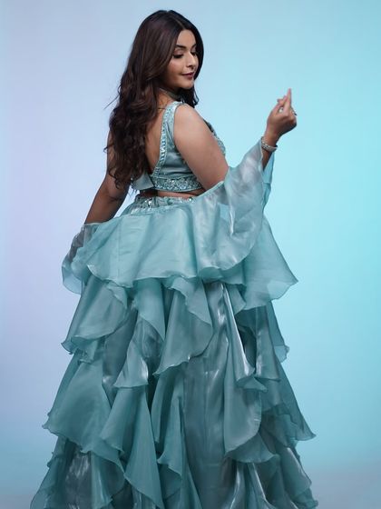 The movement of this ruffled sky-blue lehenga is just magical. The lightweight fabric and layers make it perfect for dancing all night.