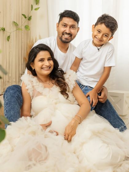 A happy family portrait, all smiles together. This shot captures the joy and togetherness of your family as you prepare to welcome a new member.