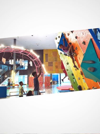 A young climber tackles a route on our vibrant, multi-colored bouldering wall. This structure offers endless fun and challenges, perfect for kids to develop their strength, balance, and problem solving skills.