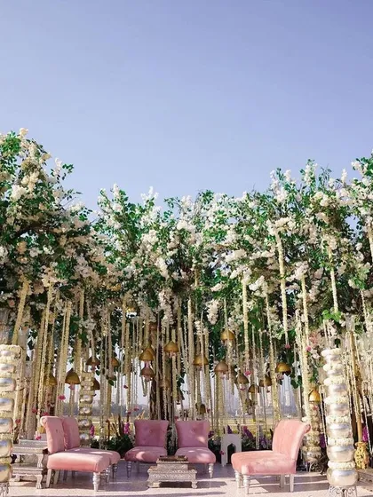 Another view of the enchanting forest-like mandap, showcasing the tall, tree-like structures covered in white blossoms. The design creates a magical, secluded space for the wedding ceremony.