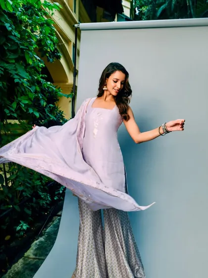 A playful twirl in the lilac House of Masaba sharara set. This outfit is all about easy elegance and modern desi style.