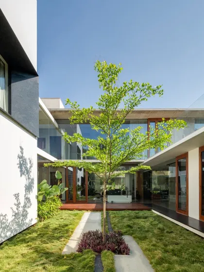 At the heart of the Long House lies this tranquil courtyard, a green lung that organizes the home's spatial flow. This design feature is central to our tropical modern style, allowing for natural ventilation and a constant visual connection to nature from every part of the house.