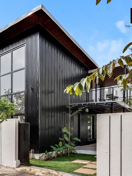 The exterior of the 550 sq. ft. loft home showcases a modern, industrial aesthetic with its black corrugated cladding and large window, making it a striking addition to any property.